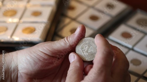 Man collector examines American silver dollar 1971 issue