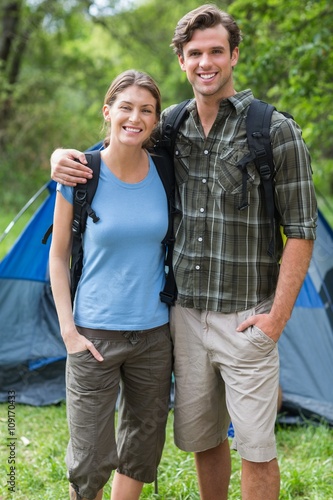 Portrait of young couple standing against tent © WavebreakMediaMicro