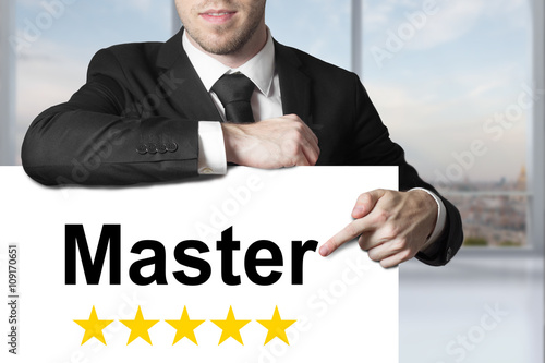 businessman pointing on sign master gold stars photo