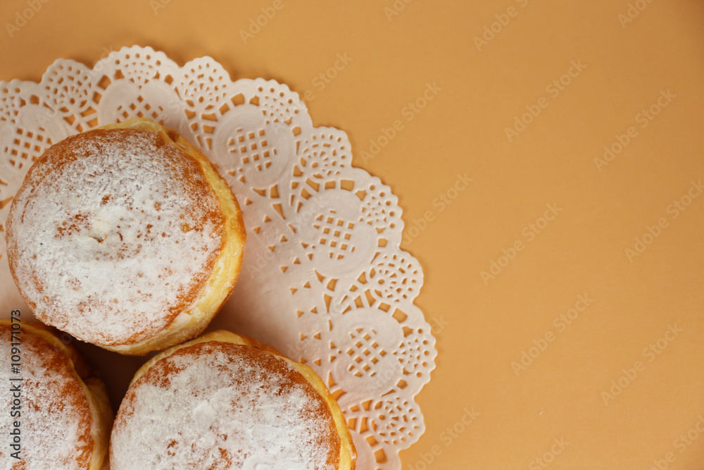 Delicious donuts with powdered sugar on napkin top view Delicious donuts with powdered sugar on napkin top view