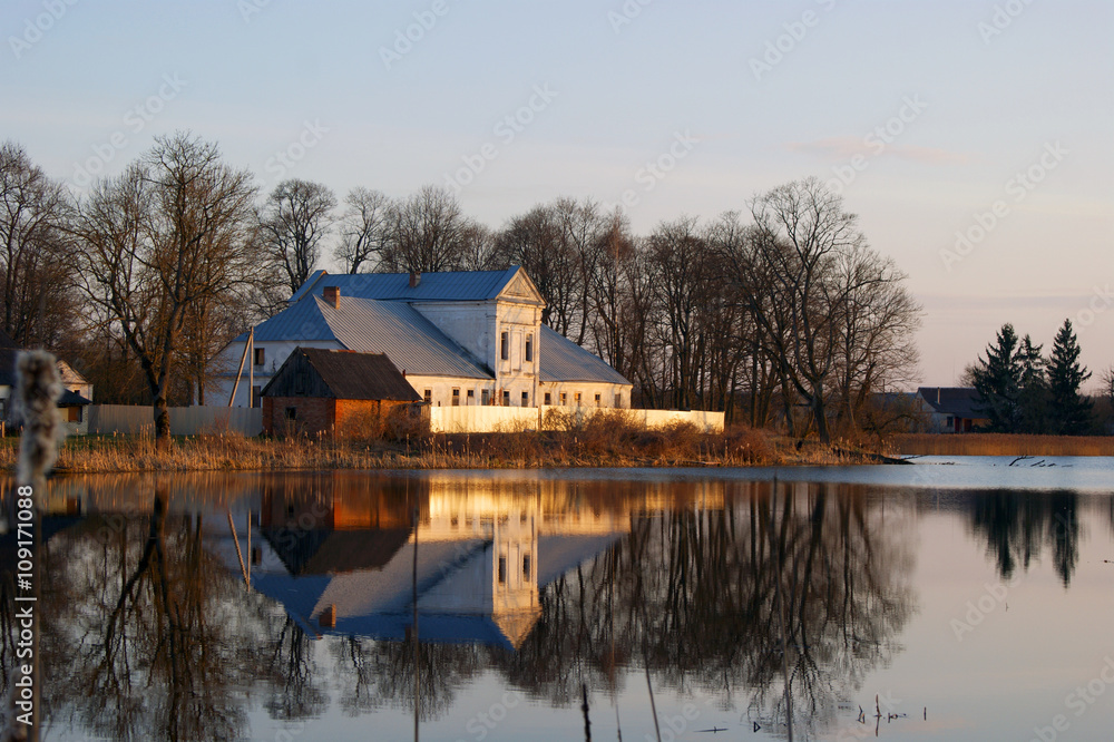 Reflection in the water of the manor house Chechot-Bohvitsev (19th century) in the village Podorosk, Belarus.