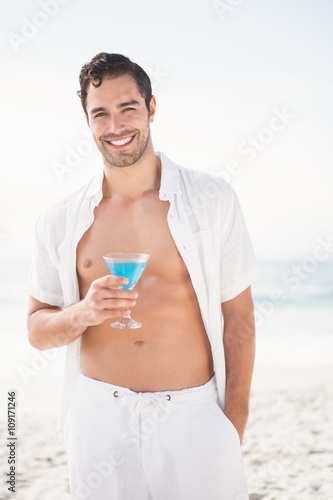 Man posing and drinking cocktail