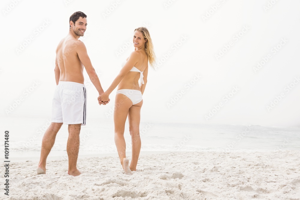 Happy couple posing on the beach Happy couple posing on the beach