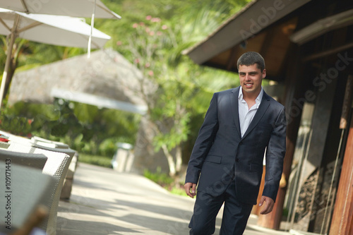 Wallpaper Mural Handsome young man walking outside restaurant across terrace. Torontodigital.ca