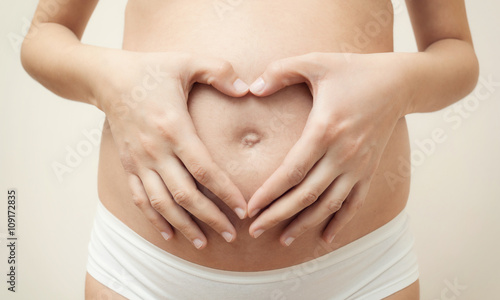 Wallpaper Mural Heart shaped hands of pregnant woman on her belly Torontodigital.ca