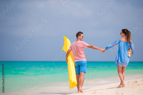 Young couple on white beach at summer vacation © travnikovstudio