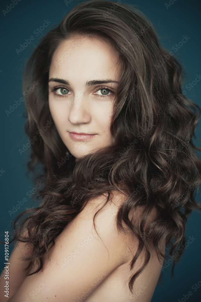 Beautiful young woman with big eyes and curly hair smiling. Beau Beautiful young woman with big eyes and curly hair smiling. Beau