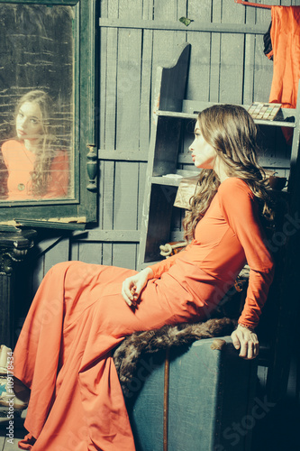 Woman in red dress near mirror © Volodymyr