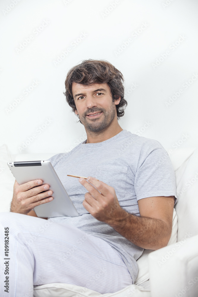 Man working at home with electronic tablet Man working at home with electronic tablet