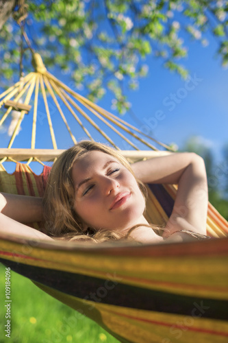 Cute Relaxing Caucasian Lady Resting in Hummock and Dreaming Outdoors © danmorgan12