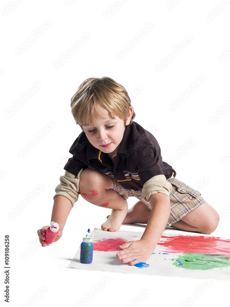 boy doing painting on piece of paper. boy doing painting on piece of paper.