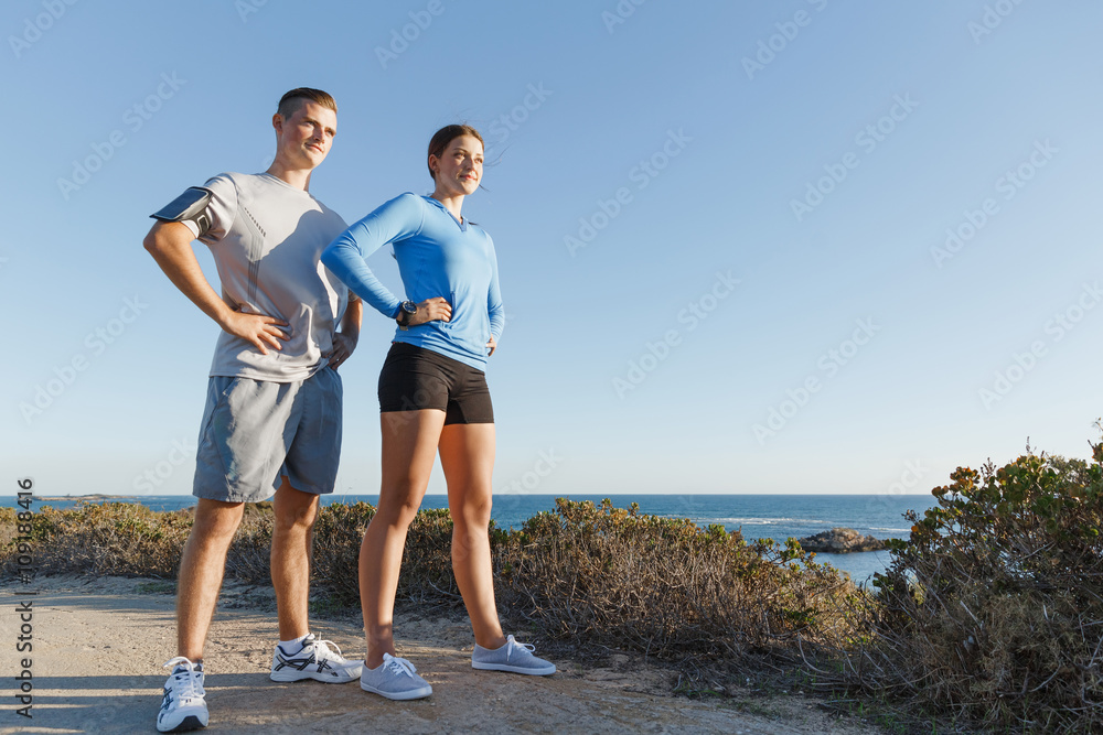 Fototapeta premium Young couple on beach training together