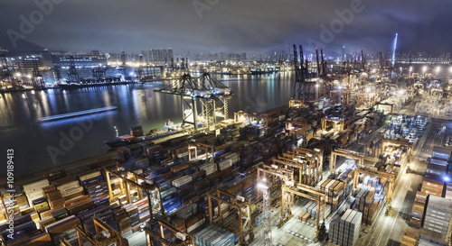 Photography Cargo ship and crane at port reflect on sea bay,