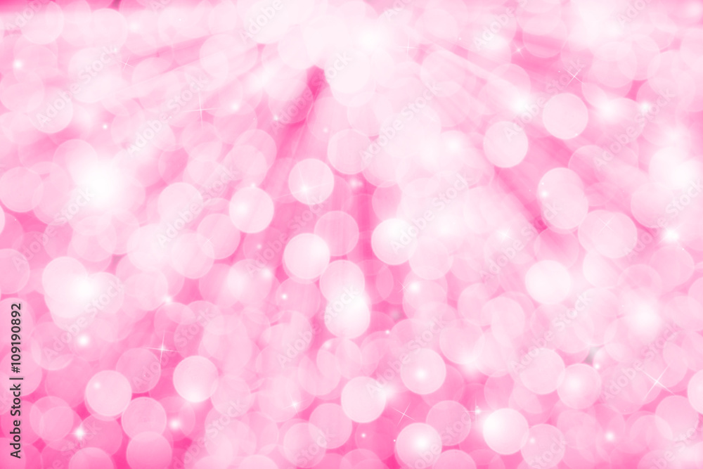 Pink glitter sparkles defocused rays lights bokeh abstract holiday background.