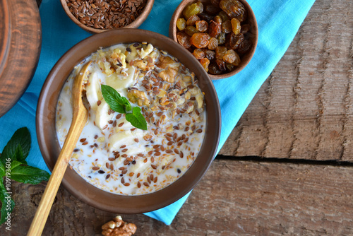 Granola with milk, walnuts and a banana for breakfast