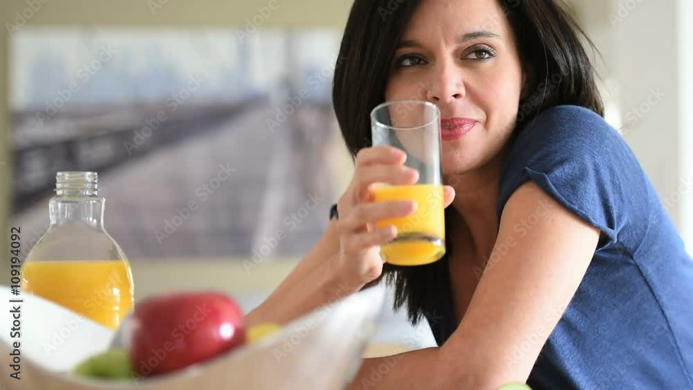 Portrait of mature woman drinking orange juice Portrait of mature woman drinking orange juice
