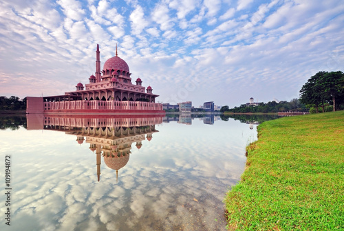 Photography Horizontal image of Morning view of Putra Mosque and mirror like reflection, The Putra mosque also known as Masjid Putra in Malay language, its the principal mosque of Putrajaya, Malaysia