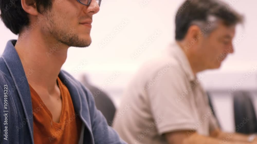 Student and teacher working on computer