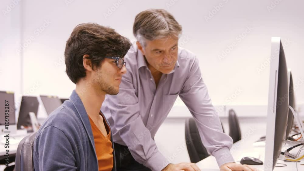 Student and teacher working on computer Student and teacher working on computer