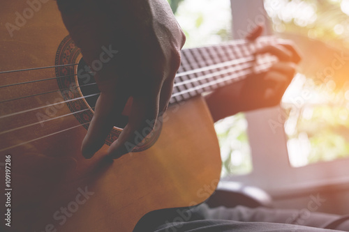 Acoustic guitar guitarist playing. Musical instrument with perfo photo