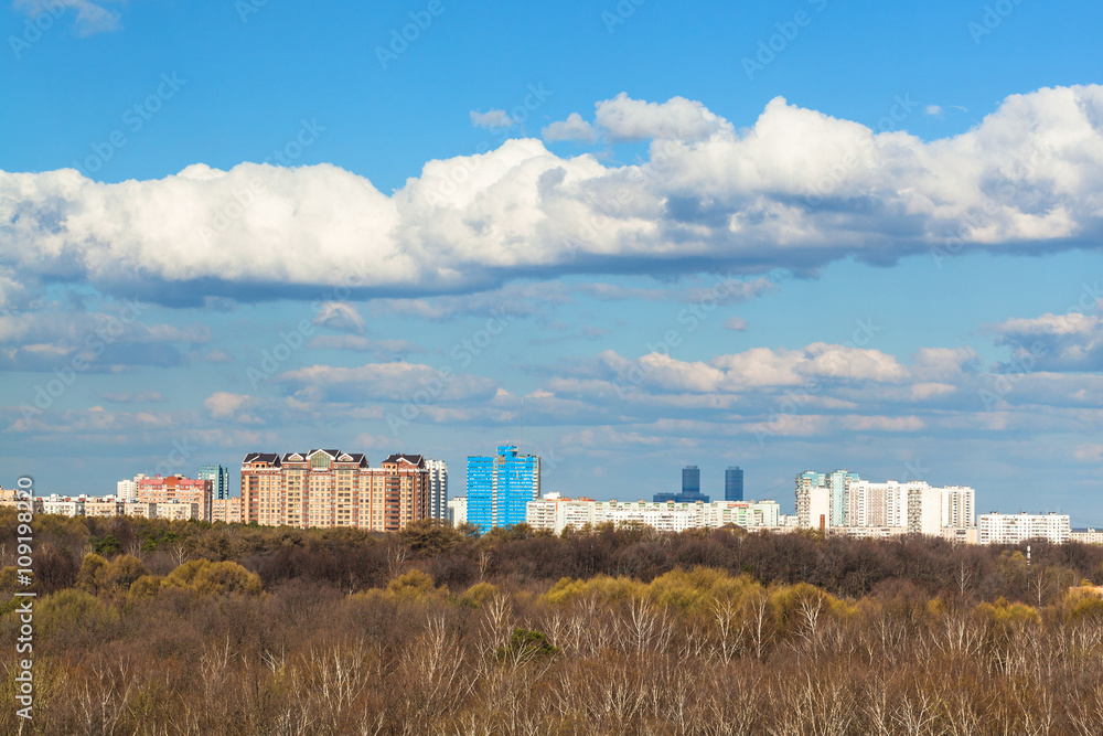 blue sky with cloud over city and forest in spring