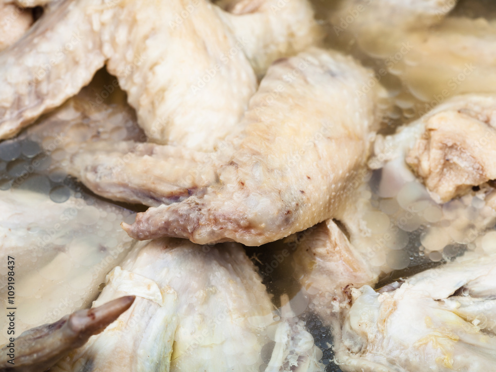 many cooked chicken wings in bouillon close up many cooked chicken wings in bouillon close up