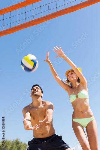 Couple playing with a ball at sea shore