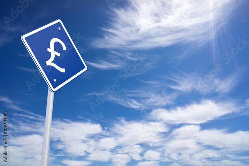 Currency concept: Pound on blue road sign, clear blue sky backgr © klenger