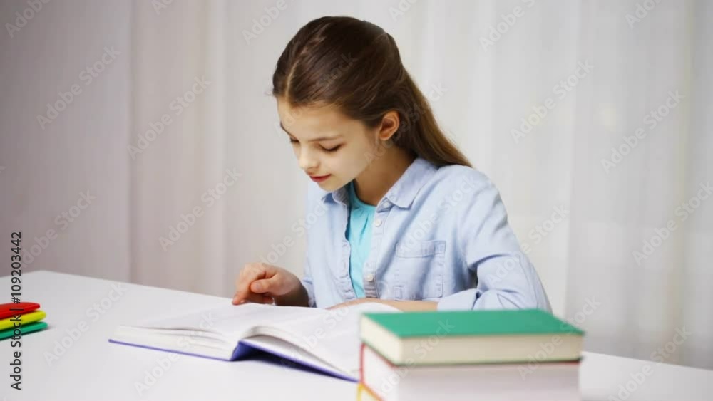 happy school girl reading book or textbook at home happy school girl reading book or textbook at home