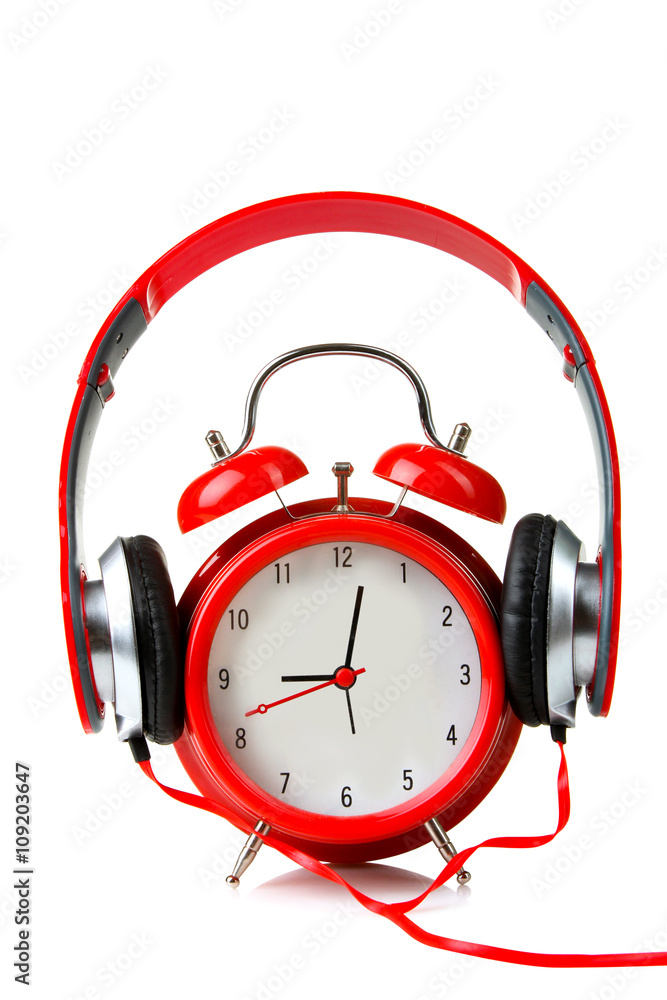 full-size wired headphones dressed on a clockwork alarm clock on white  isolated background Stock Photo | Adobe Stock
