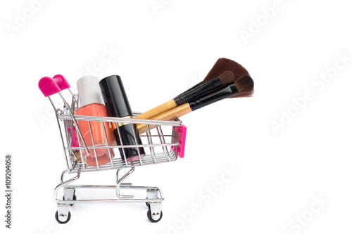 Shopping cart with cosmetics on with background.