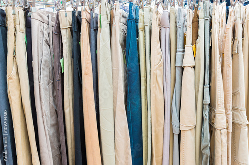 clothes hanging on a rack in a flea market © nonchanon