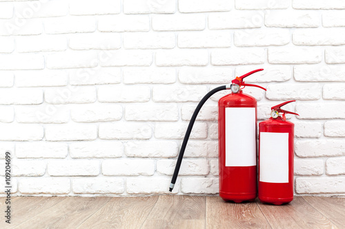Wallpaper Mural Fire extinguisher near white wall, ready for use Torontodigital.ca