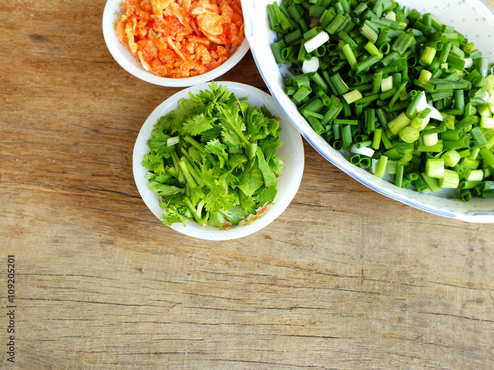 chopped green onions and coriander with dried shirmp on the wooden background chopped green onions and coriander with dried shirmp on the wooden background