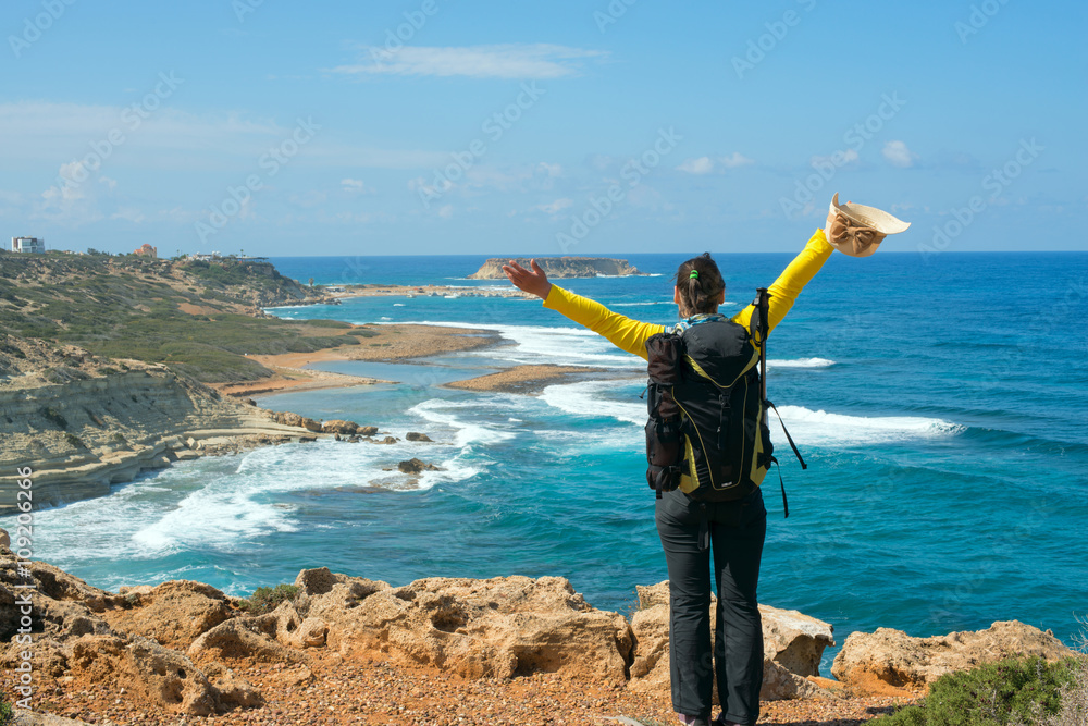 Happy hiker woman on sea shore