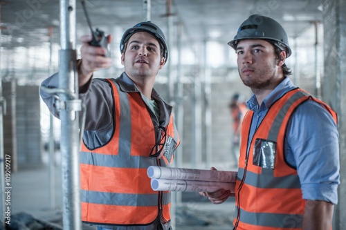 Tablou pe pânză Site manager and builder pointing on construction site