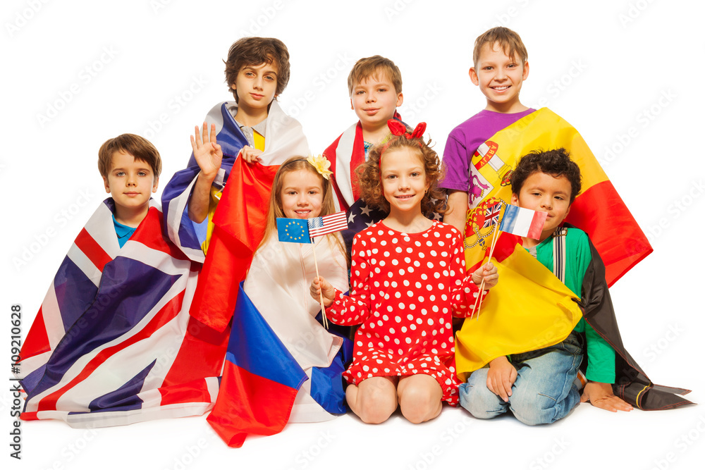 Seven kids with flags wrapped in different banners Seven kids with flags wrapped in different banners