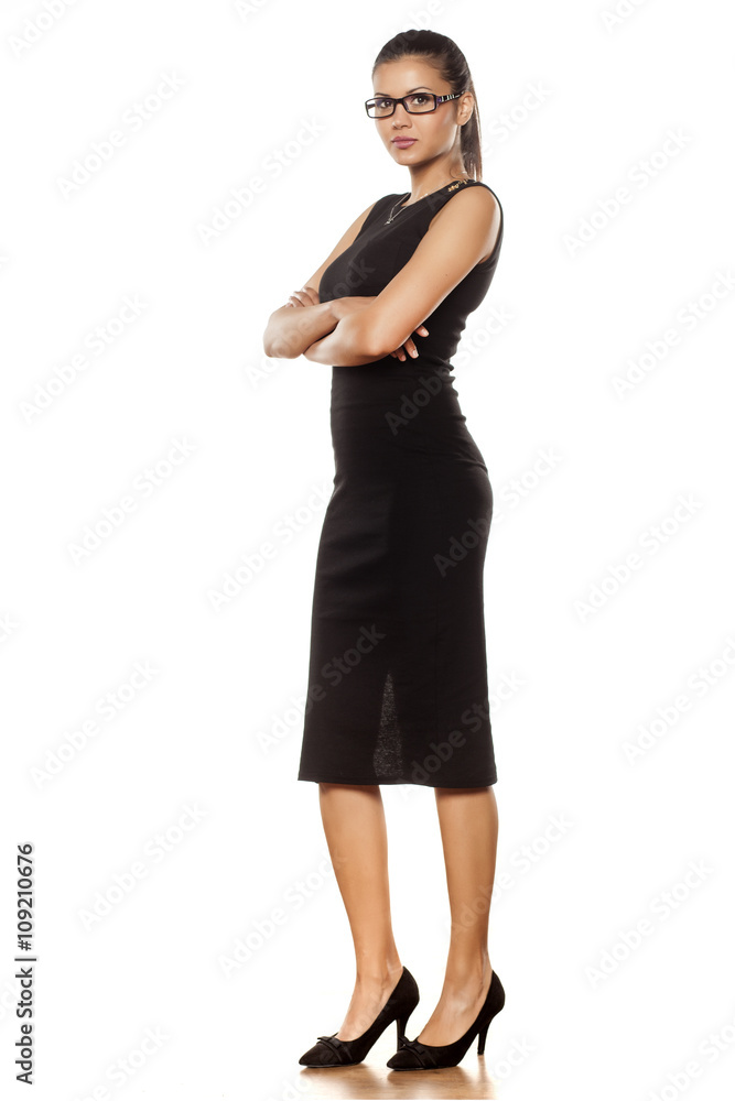 beautiful young woman in a tight black dress posing in the studio beautiful young woman in a tight black dress posing in the studio