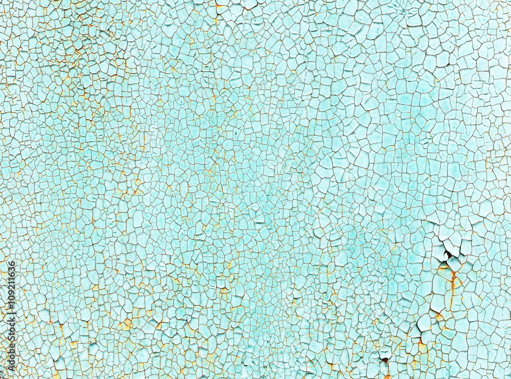 Naklejka premium Crackles of paint on the old green wall.