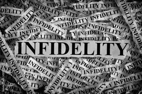 Torn pieces of paper with the word Infidelity