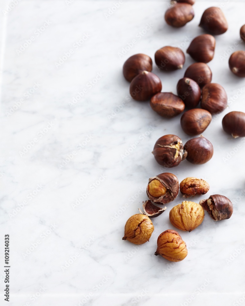 Overhead view of fresh chestnuts on marble table Overhead view of fresh chestnuts on marble table