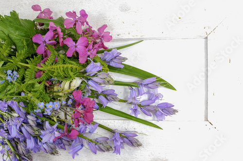 Bouquet with colorful forest flowers on  wooden background