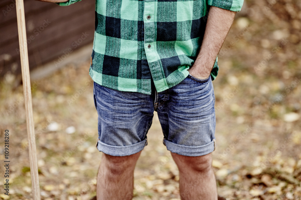 Man in denim shorts, mid section Man in denim shorts, mid section