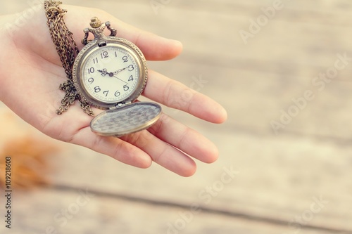 Still life with retro watch on is wooden background