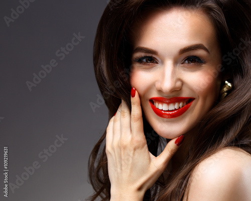 Beauty Model Woman with Long Brown Wavy Hair. Healthy Hair and Beautiful Professional Makeup. Red Lips and Smoky Eyes Make up. Gorgeous Glamour Lady Portrait. Haircare