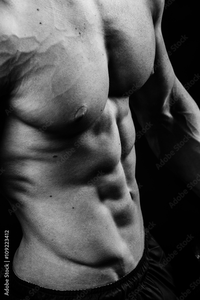 Closeup of cool perfect sexy strong sensual bare torso with abs pectorals 6 pack muscles chest black and white studio, vertical picture Closeup of cool perfect sexy strong sensual bare torso with abs pectorals 6 pack muscles chest black and white studio, vertical picture