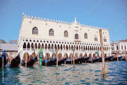 venetian gondolas and tower in canal of Venice, Italy.