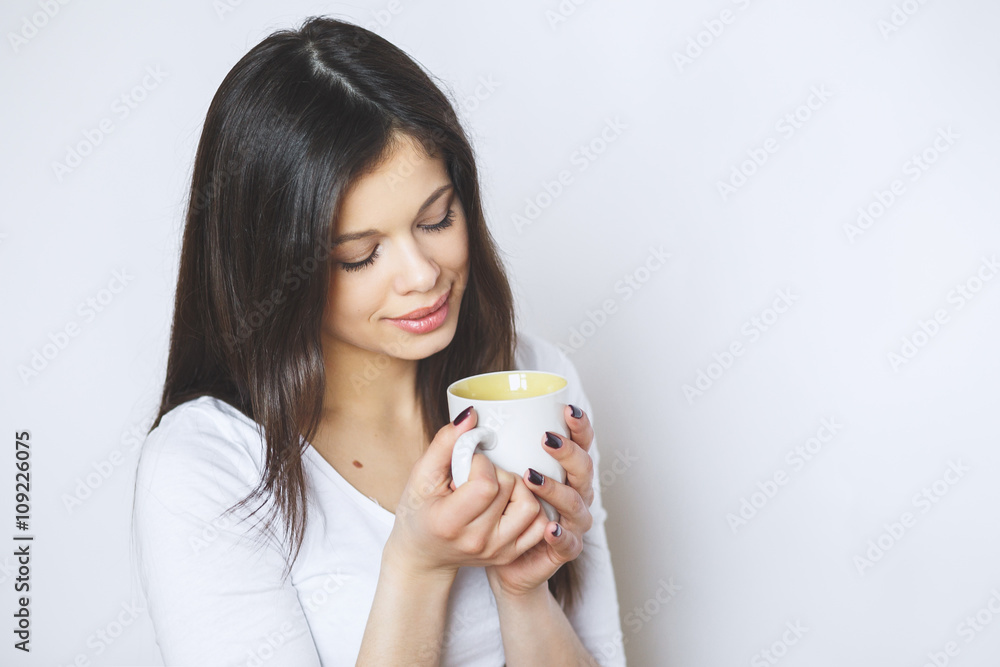 young pretty woman drinking coffee or tea . Relaxing girl . Woman drinking coffee in the morning at home lifestyle. young pretty woman drinking coffee or tea . Relaxing girl . Woman drinking coffee in the morning at home lifestyle.