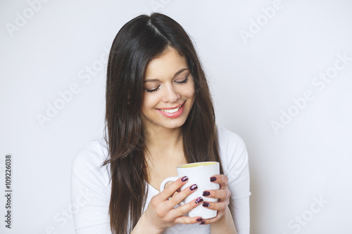 young pretty woman drinking coffee or tea . Relaxing girl . Woman drinking coffee in the morning at home lifestyle.