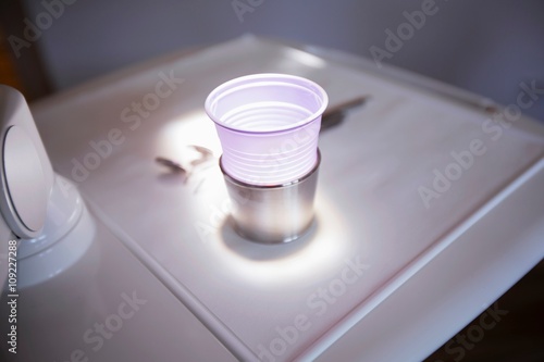 High angle view of illuminated disposable cup in dentists clinic photo